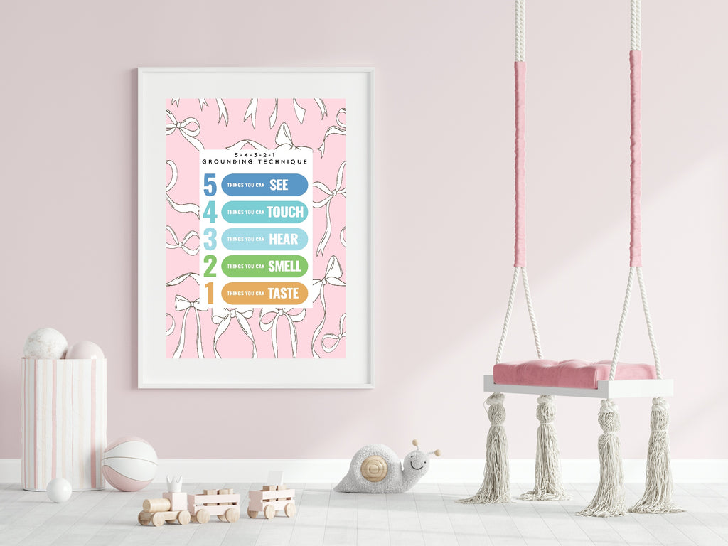 Framed educational poster on a pink wall with a swing in the foreground