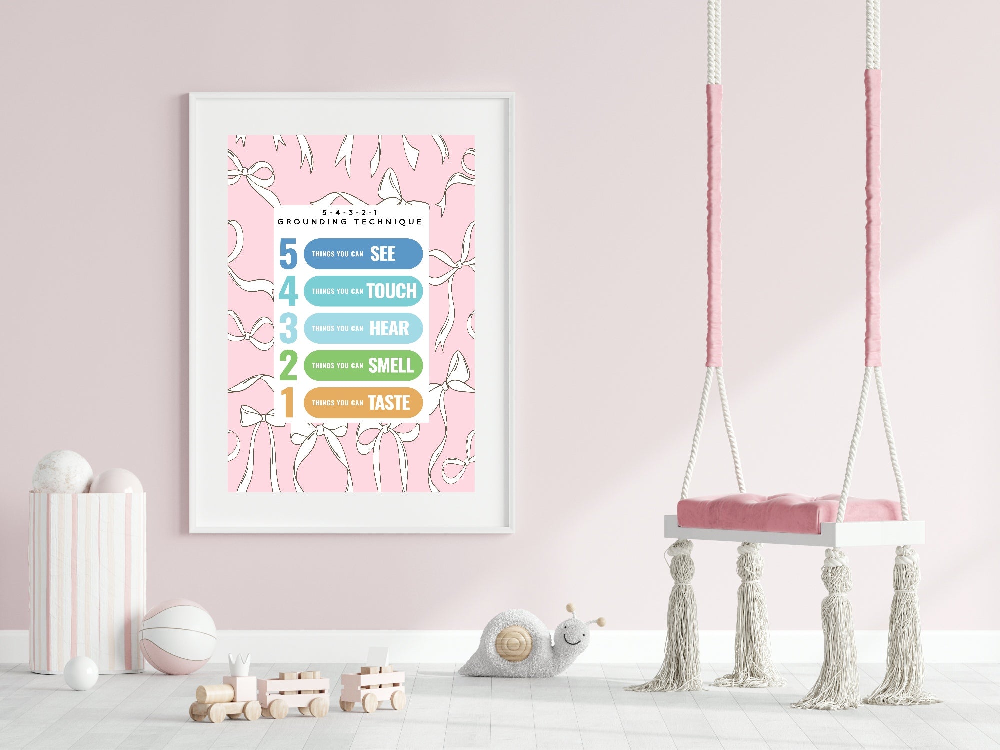 Framed educational poster on a pink wall with a swing in the foreground