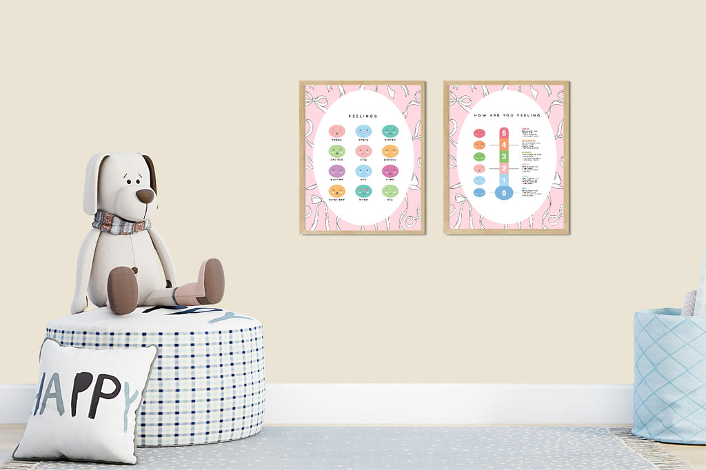 Two framed educational posters on a wall with a plush toy and decorative items below.