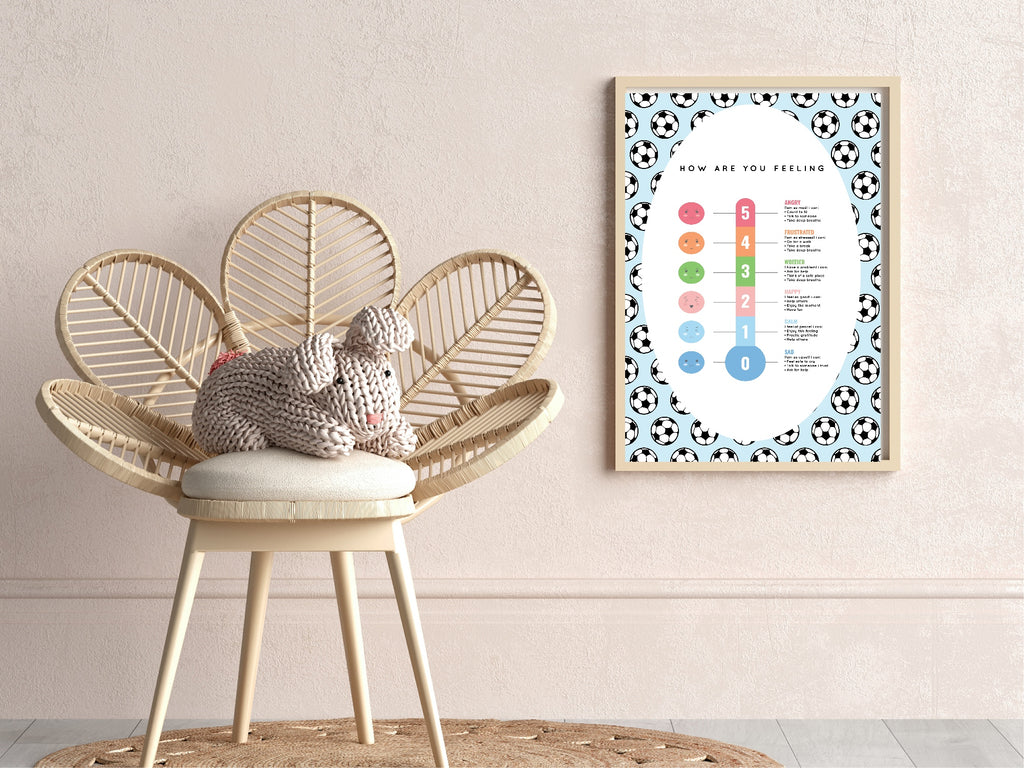 Wicker chair with a knitted toy next to a framed chart on a wall.