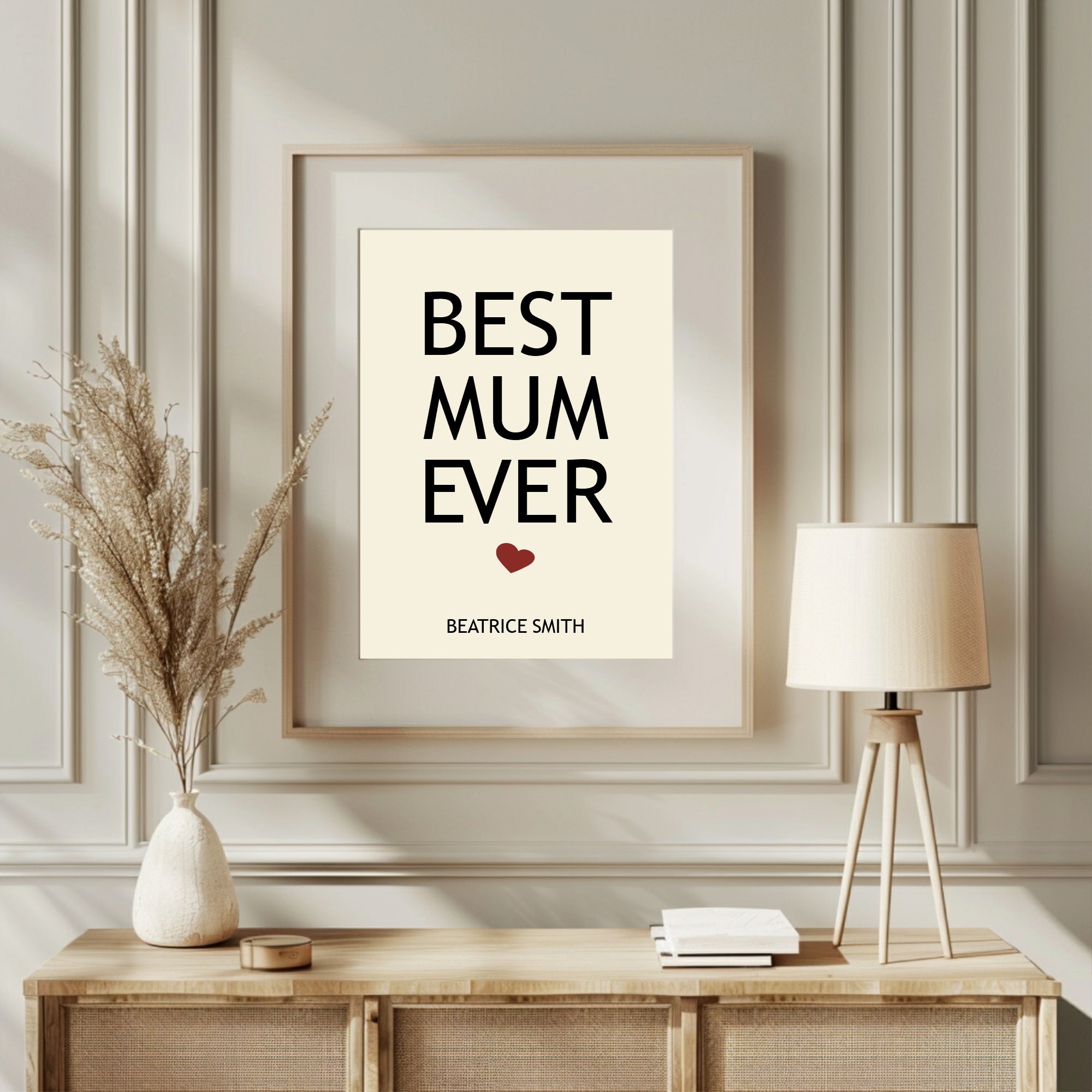 Framed print with 'Best Mum Ever' text on a wall above a wooden console table.