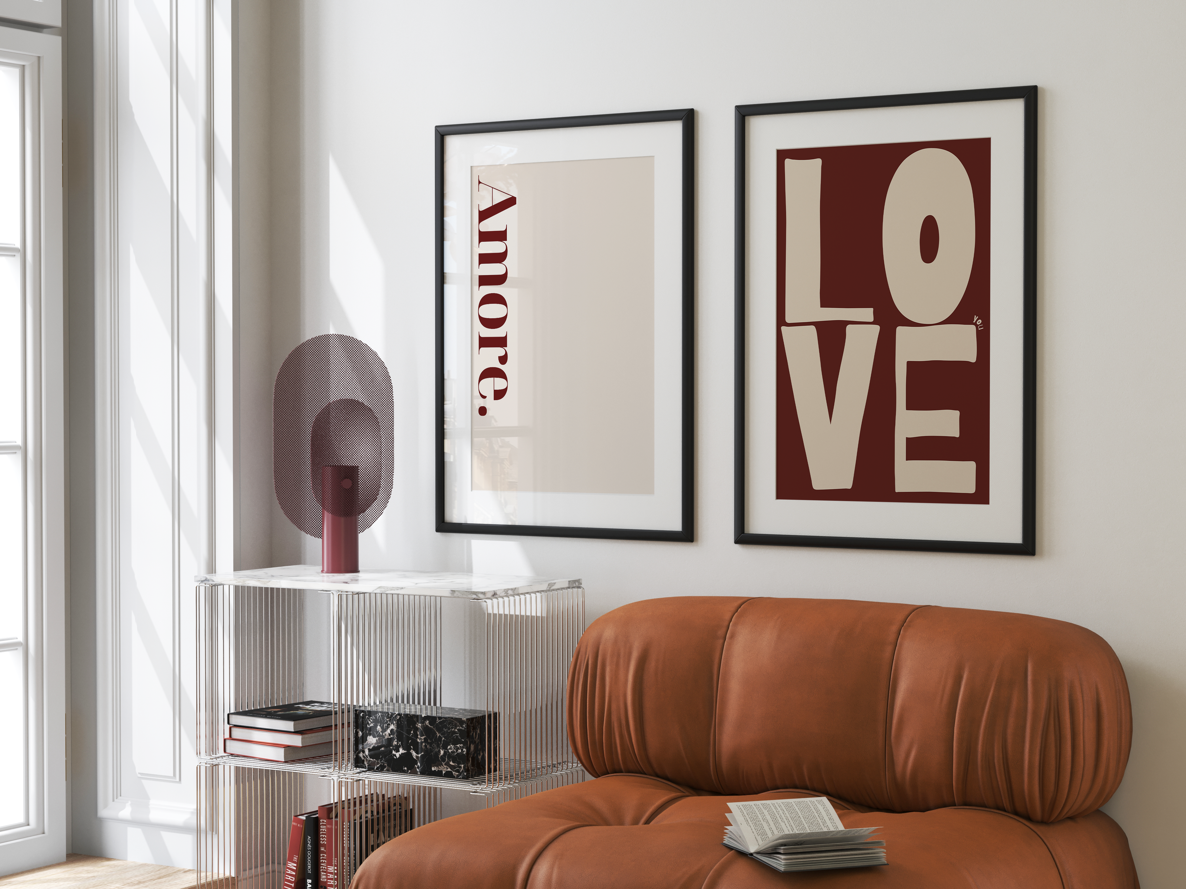 Living room with a brown leather sofa, white wall, and framed art pieces.