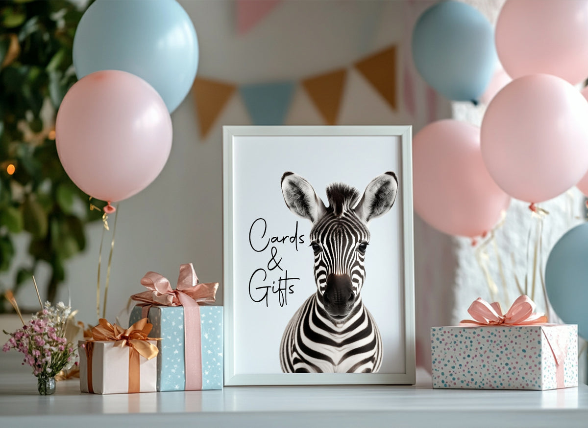 Framed zebra print with 'Cards & Gifts' text on a table with balloons and presents.