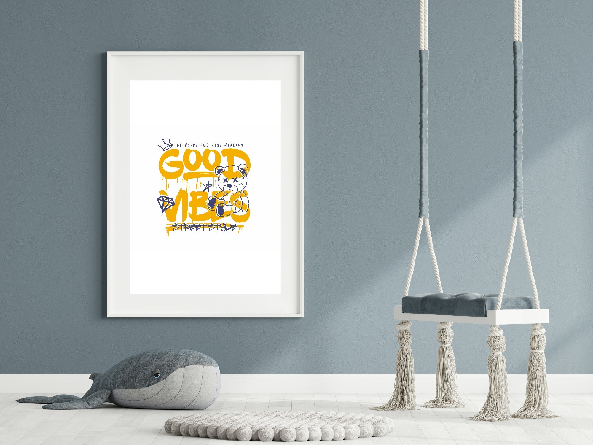 Framed artwork with text on a wall above a toy whale and two swings.