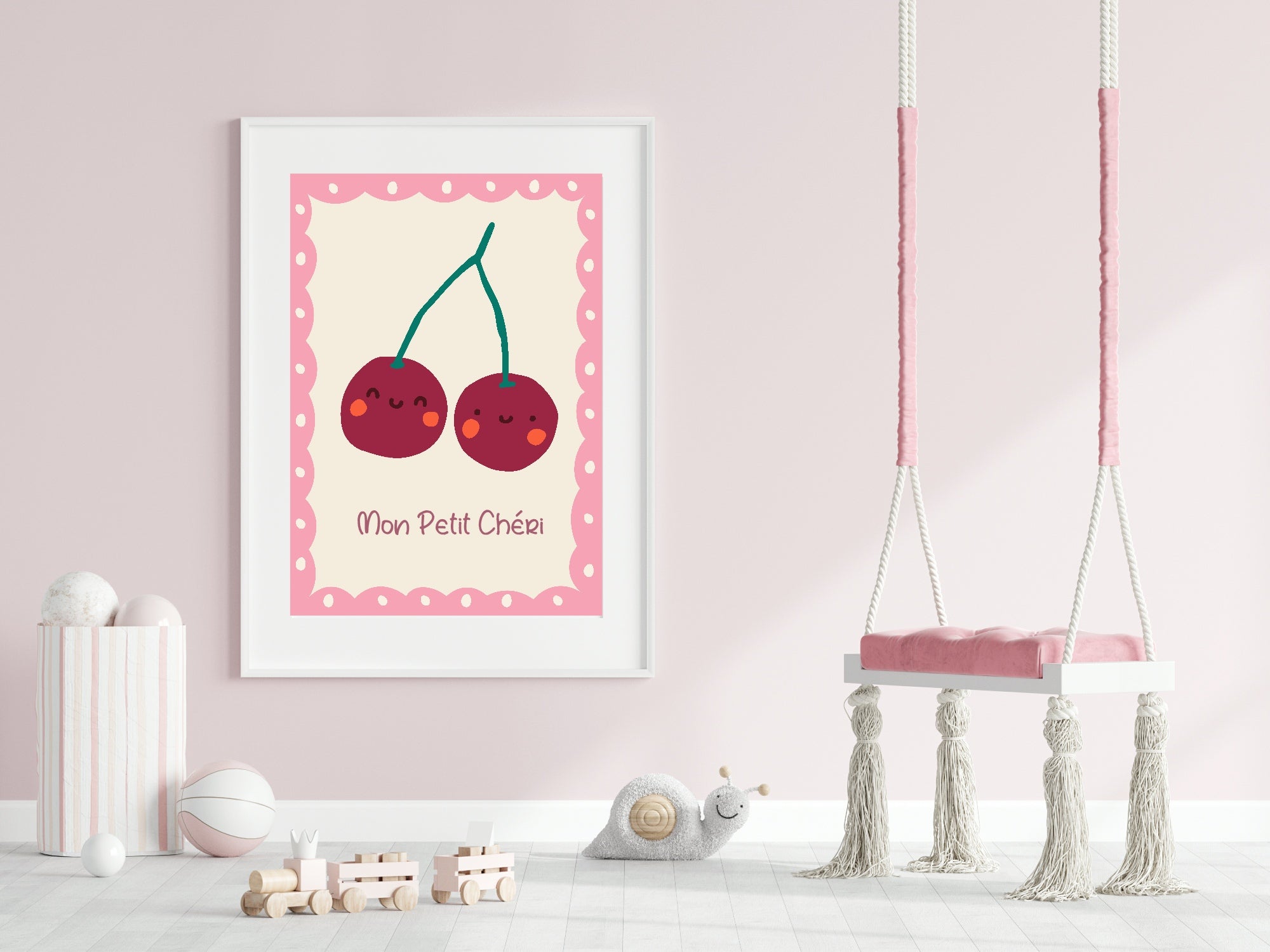 Framed illustration of cherries with a pink border on a light pink wall, next to a children's swing.