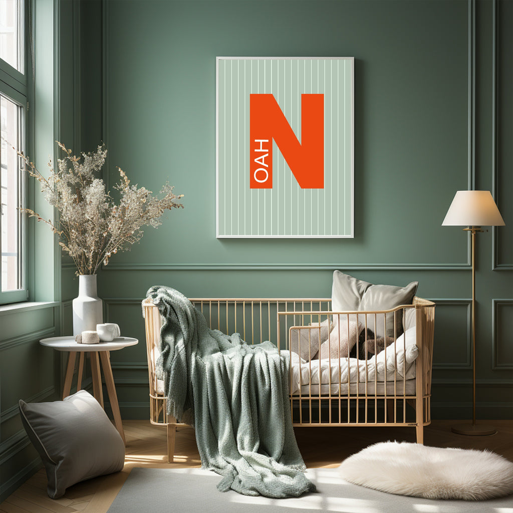 Nursery room with a crib, decorative pillows, and a framed picture on a green wall.