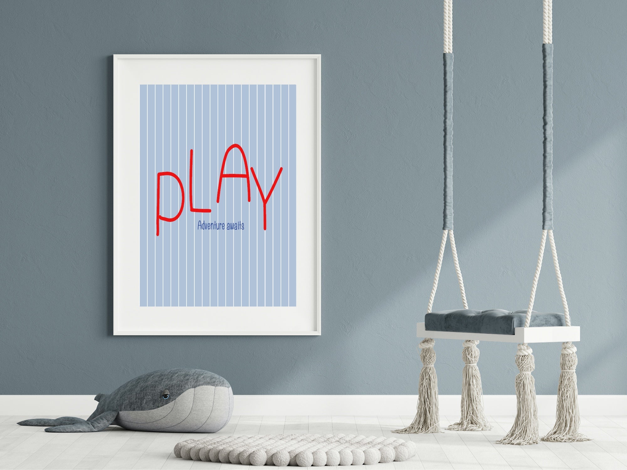 Framed poster with 'PLAY' text in a room with swings and a plush toy.