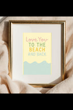 Framed print with 'Love You to the Beach and Back' text on a soft fabric background