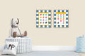 Two educational posters on a wall with a stuffed dog toy and decorative items below.