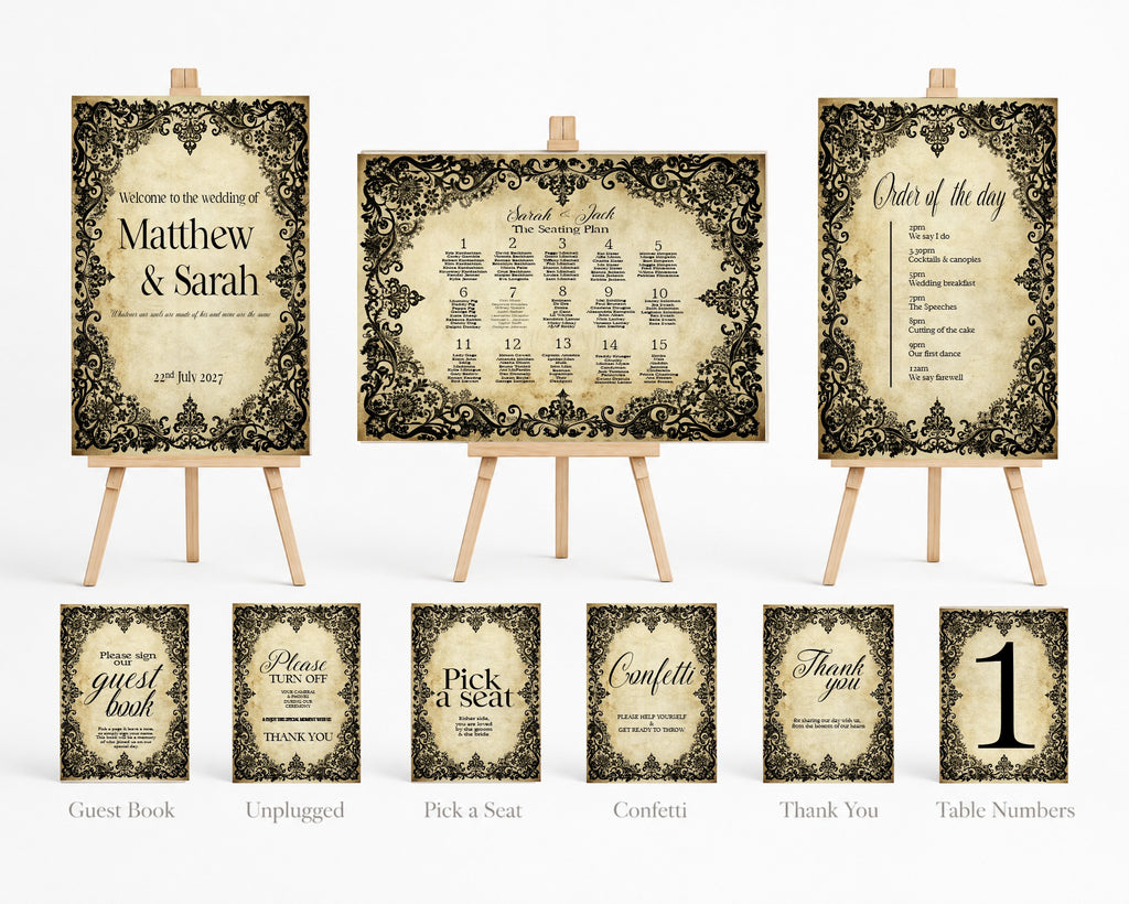 A coordinated wedding stationery set displayed on small wooden easels, including a guest book, unplugged sign, pick a seat sign, confetti sign, thank you sign, table numbers sign, and three matching printed cards. The design uses a distressed beige background with ornate black damask-style borders and elegant script text.