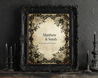 Decorative print with floral frame and 'Matthew & Sarah' text, framed in an ornate black frame against a dark textured wall.