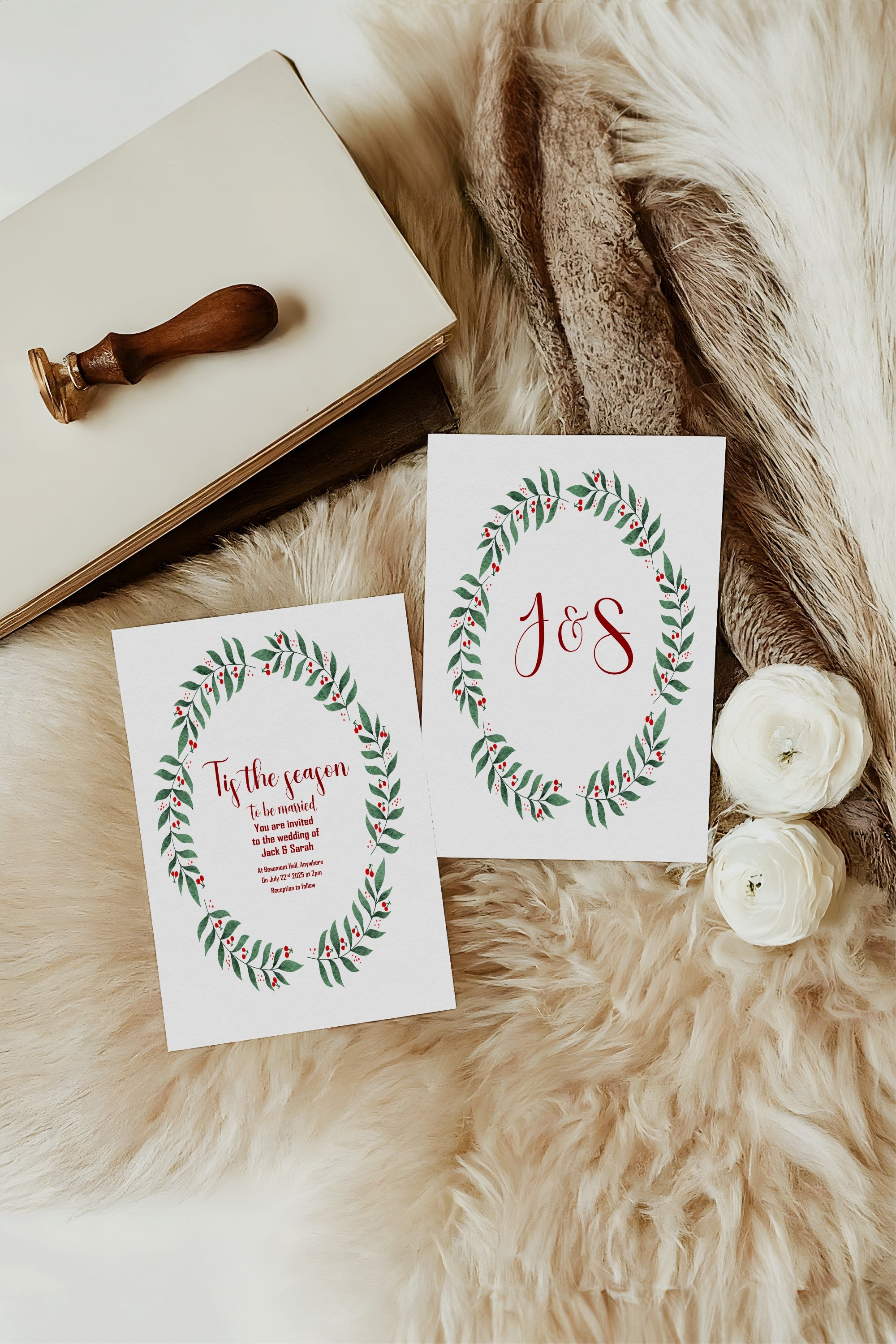Two greeting cards with floral designs and 'J&S' on a textured surface with a stamp and flowers.