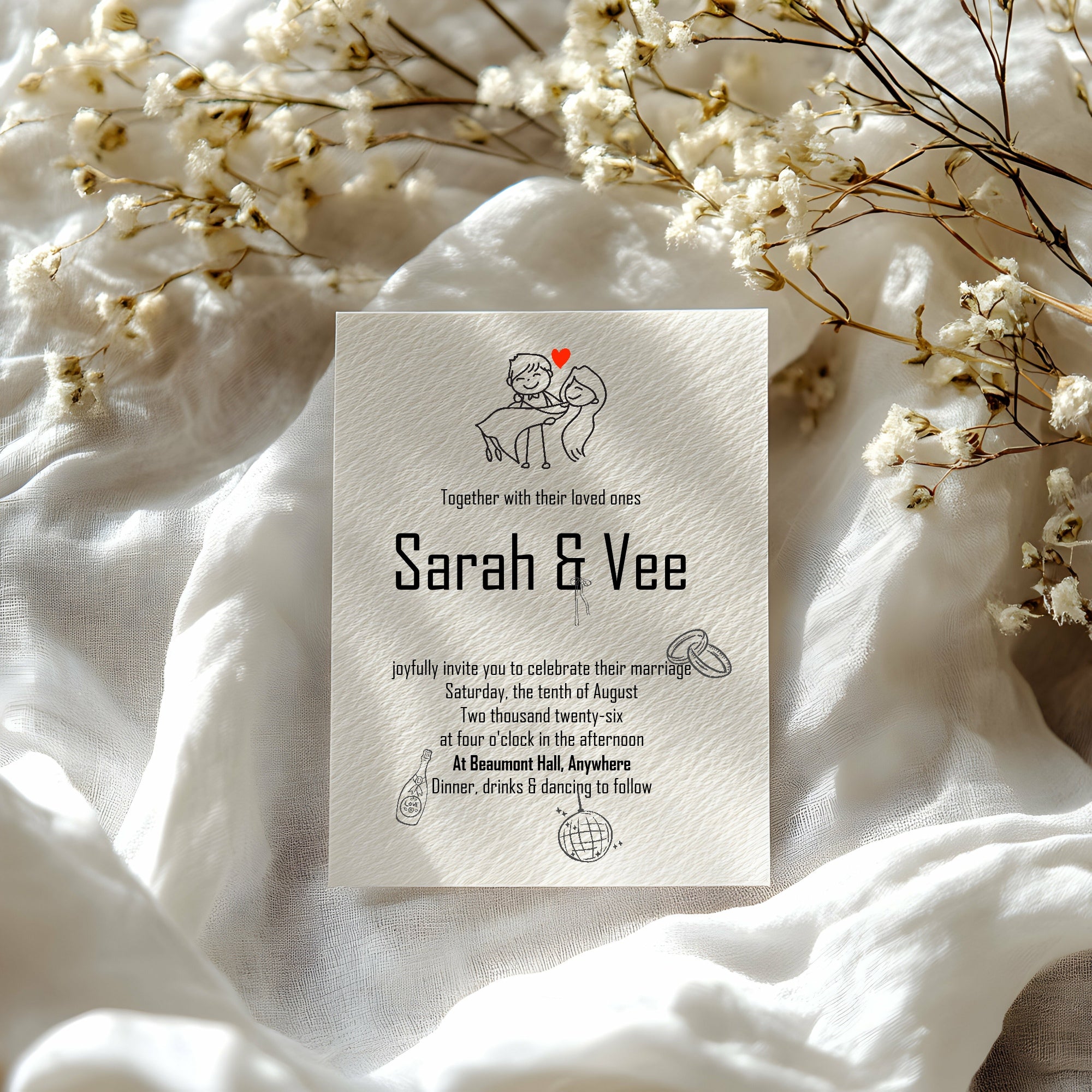 Wedding invitation card with floral decorations on a white fabric background