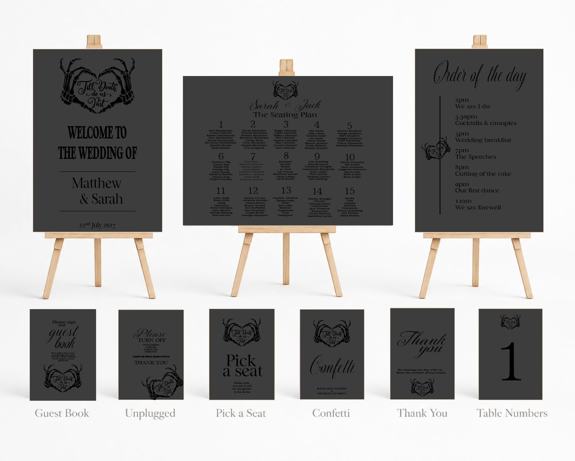 A coordinated wedding stationery set displayed on small wooden easels and shown as individual card views below. The set includes a guest book, unplugged sign, pick a seat sign, confetti sign, thank you sign, and table numbers, all in a dark charcoal/black finish with light wood easels and small gold accents.