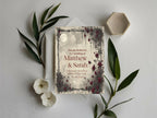 Personalised Moon and Rose wedding invitation with burgundy roses beside green foliage