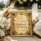 Spell Book personalised wedding welcome sign shown in a gold frame beside dried flowers