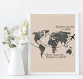 Beige map print in a white frame beside flowers